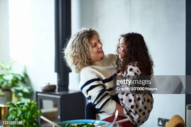 grandmother holding granddaughter and smiling - british granny - fotografias e filmes do acervo