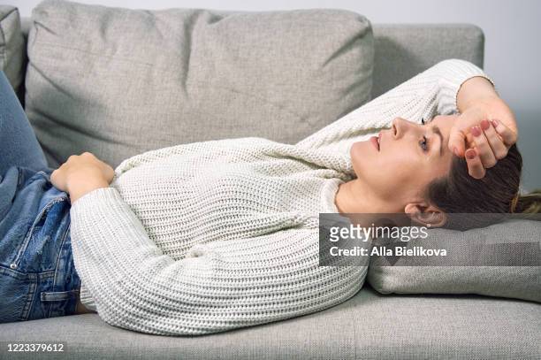 a woman has a stomach ache. - pms stock pictures, royalty-free photos & images