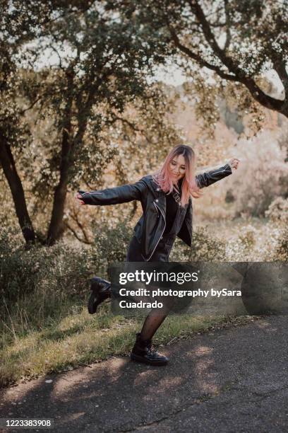 young woman jumping - black tights stock pictures, royalty-free photos & images