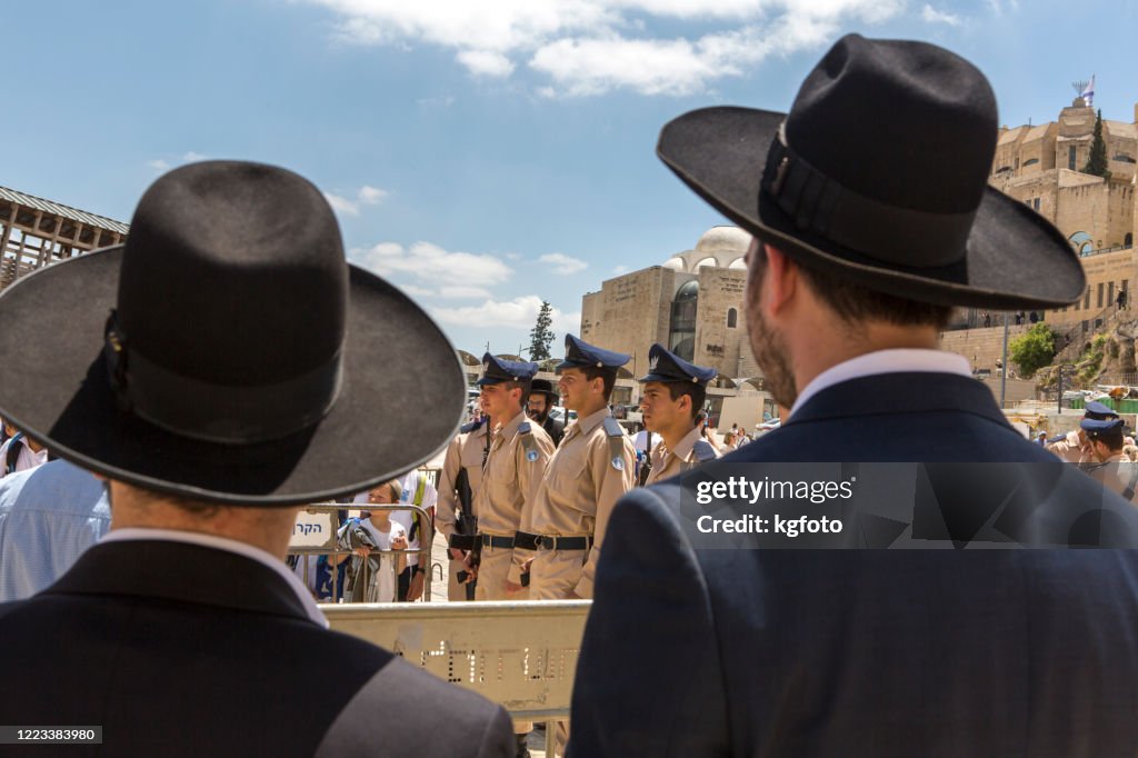 Israel orthodox jews looking at israeli soldiers on Israel's Memorial Day, at Wailing Wall in Jerusalem Old City, Israel