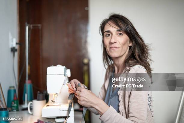 portrait of woman sewing at home - sewing stock pictures, royalty-free photos & images