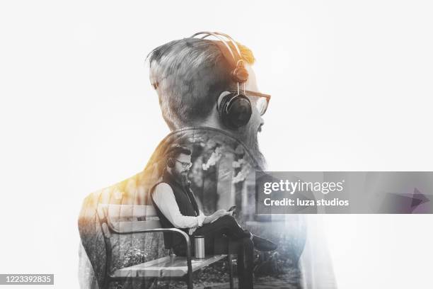 hombre escuchando podcast double exposure concept - central fotografías e imágenes de stock