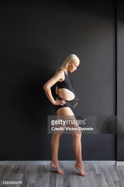 vertical portrait of a beautiful pregnant woman - beautiful black women in bathing suits stock pictures, royalty-free photos & images
