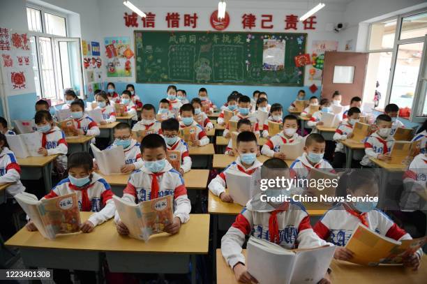 Students wearing face masks have a class at a primary school on May 7, 2020 in Huhhot, Inner Mongolia Autonomous Region of China. A part of primary...