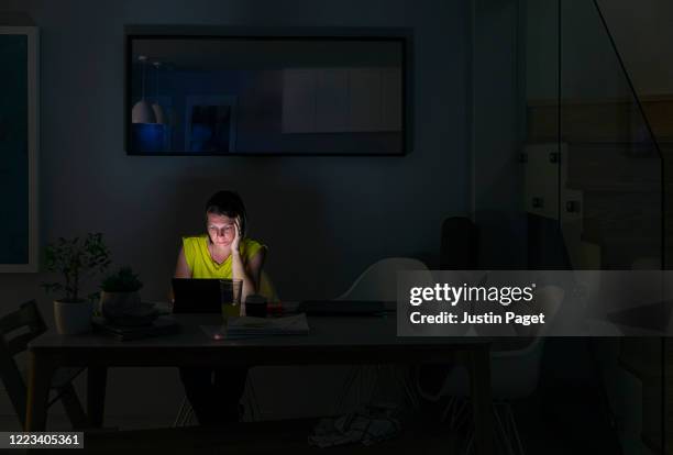 woman working from home late at night - working late foto e immagini stock