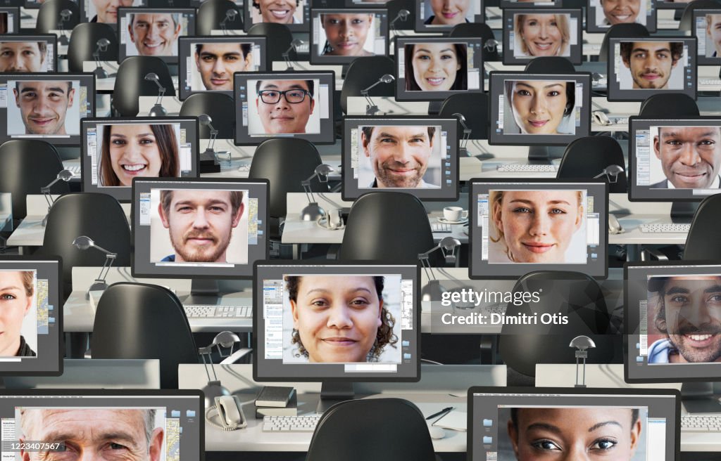 Many Computers In Large Office With Faces On Screens High-Res Stock ...