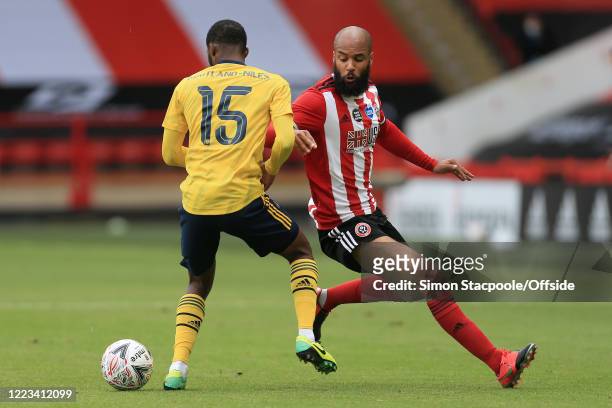 Ainsley Maitland-Niles of Arsenal battles with David McGoldrick of Sheff Utd during the FA Cup Fifth Quarter Final match between Sheffield United and...