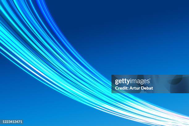 abstract picture of bright light trails crossing the blue sky with fast motion. - light trail technology stock pictures, royalty-free photos & images