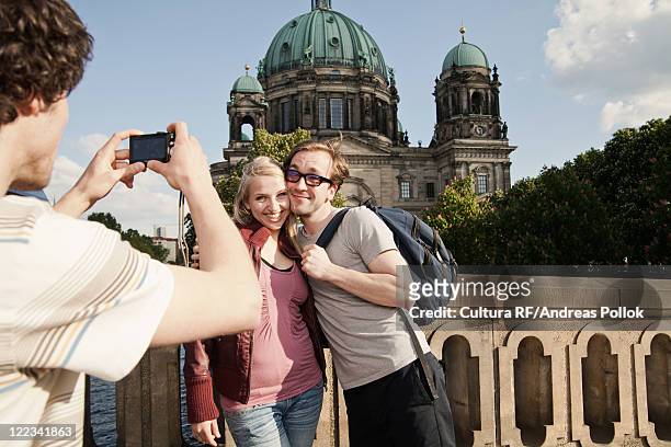 man taking picture of couple - creative rf stockfoto's en -beelden