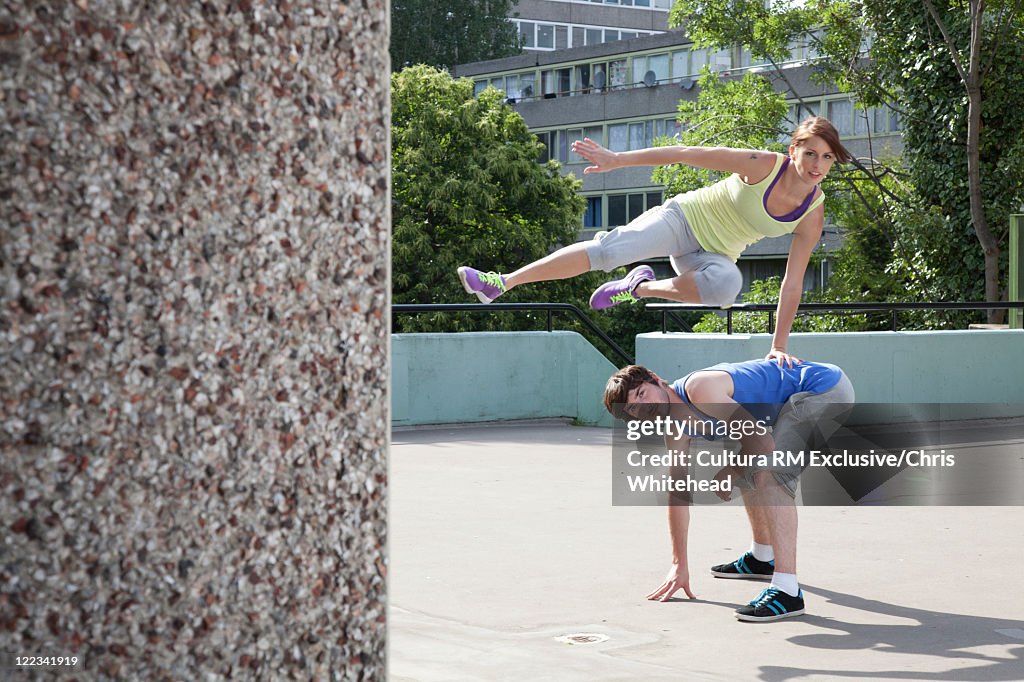 Couple free running on city street