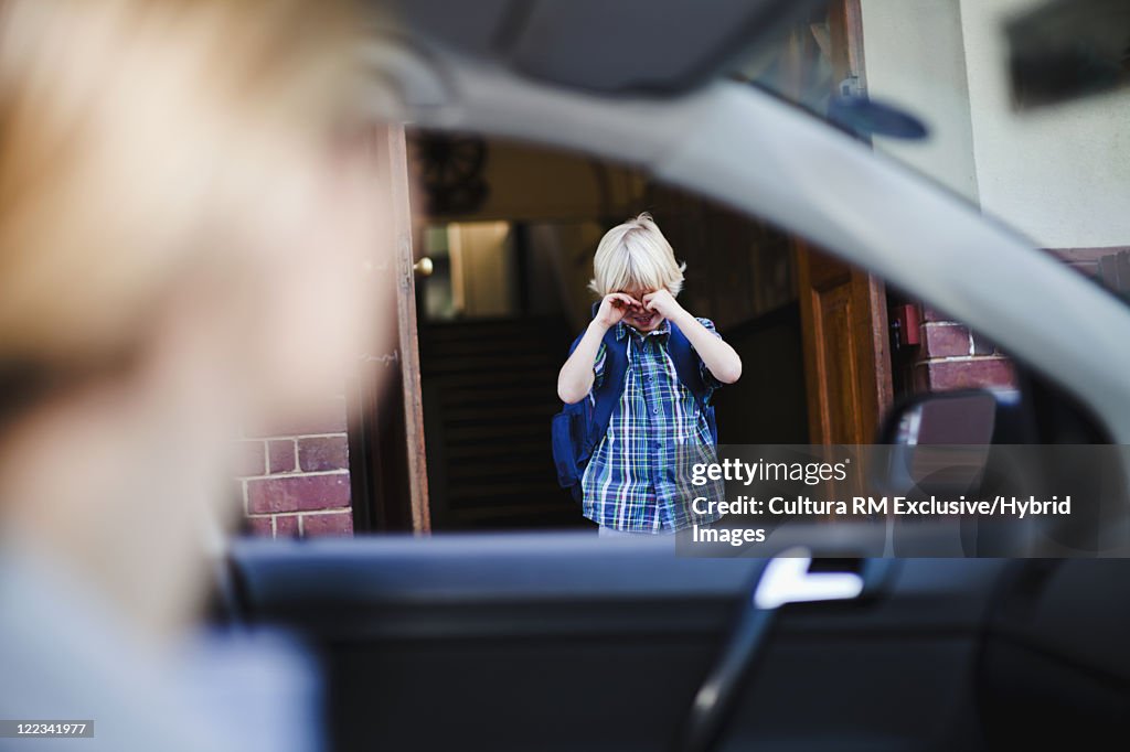 Boy crying and going to school