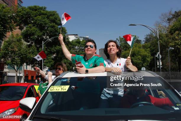 Demonstrators in cars hold flags and shout slogans during a caravan protest against the government of President of Mexico Andres Manuel Lopez Obrador...