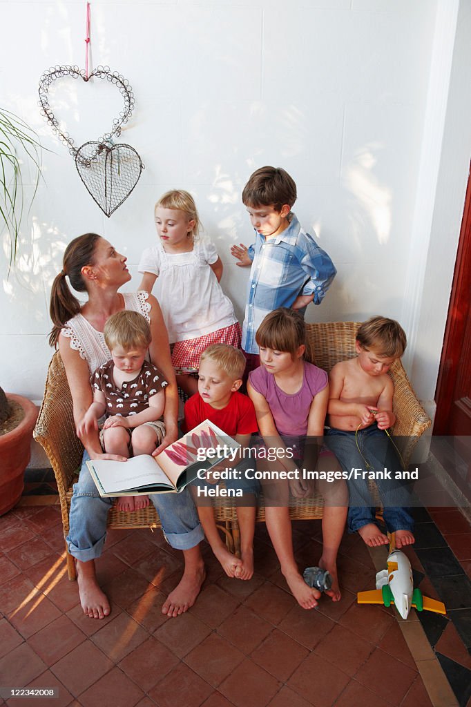 Mother and children sharing bench