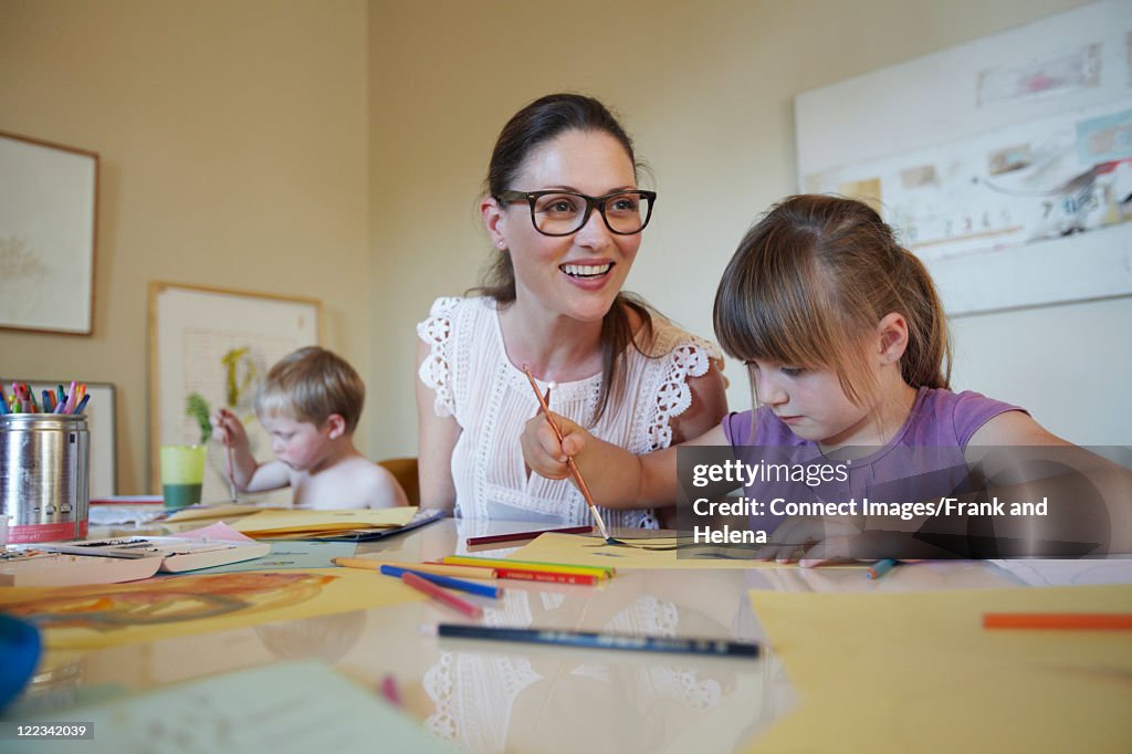Mother and children painting together