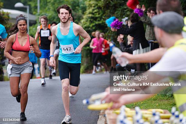 runners racing in marathon - marathon stock pictures, royalty-free photos & images