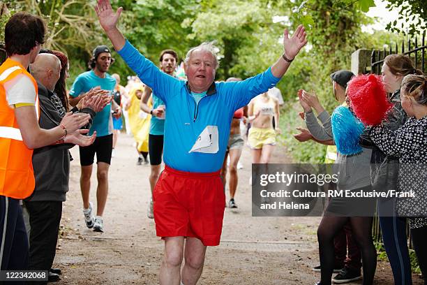 man cheering and finishing marathon - marathon runner finish line stock pictures, royalty-free photos & images