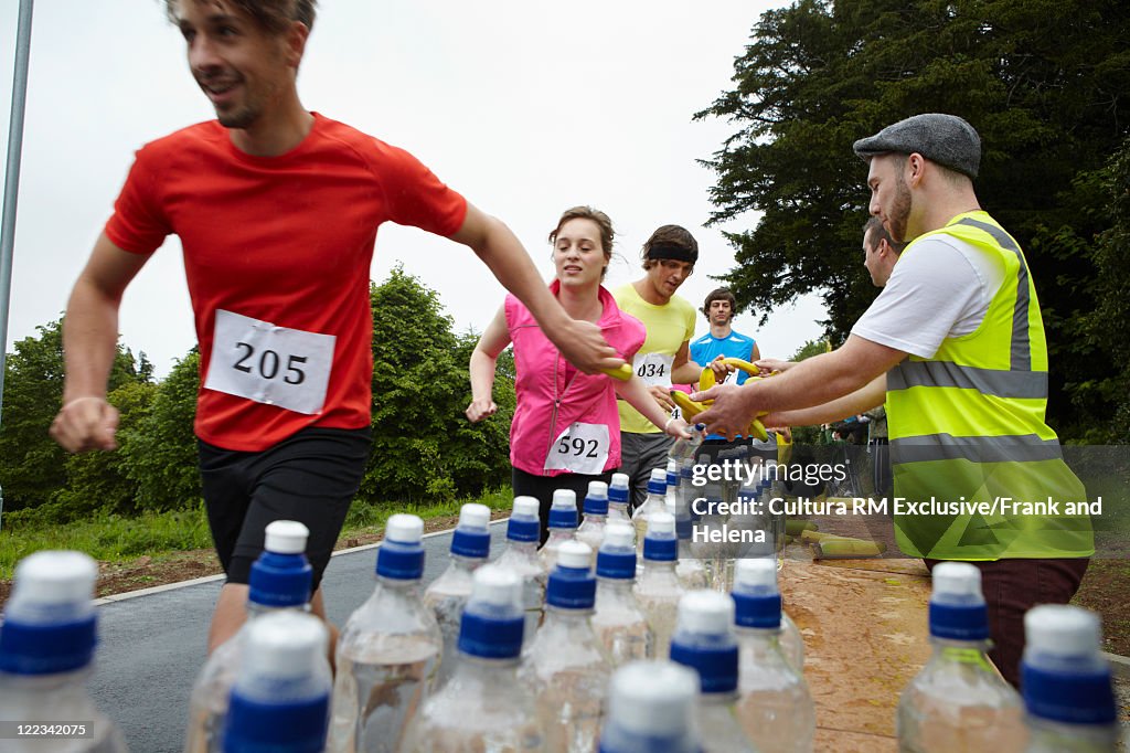 Runners having bananas in marathon