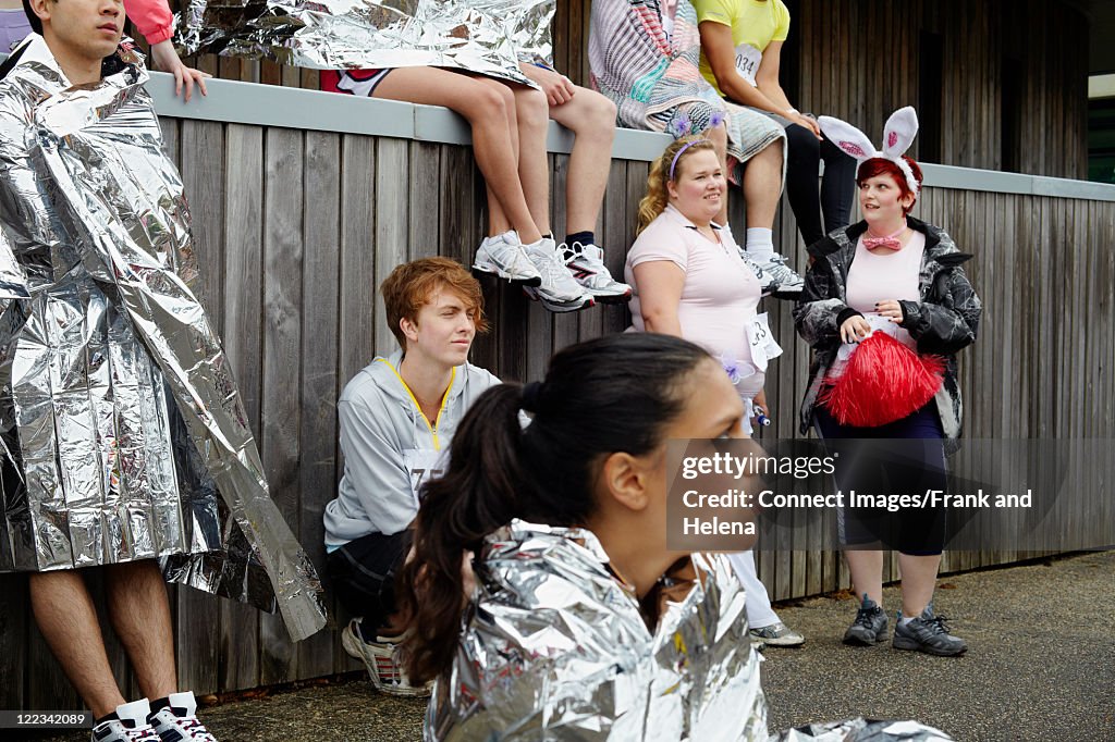 Runners in foil blankets at marathon