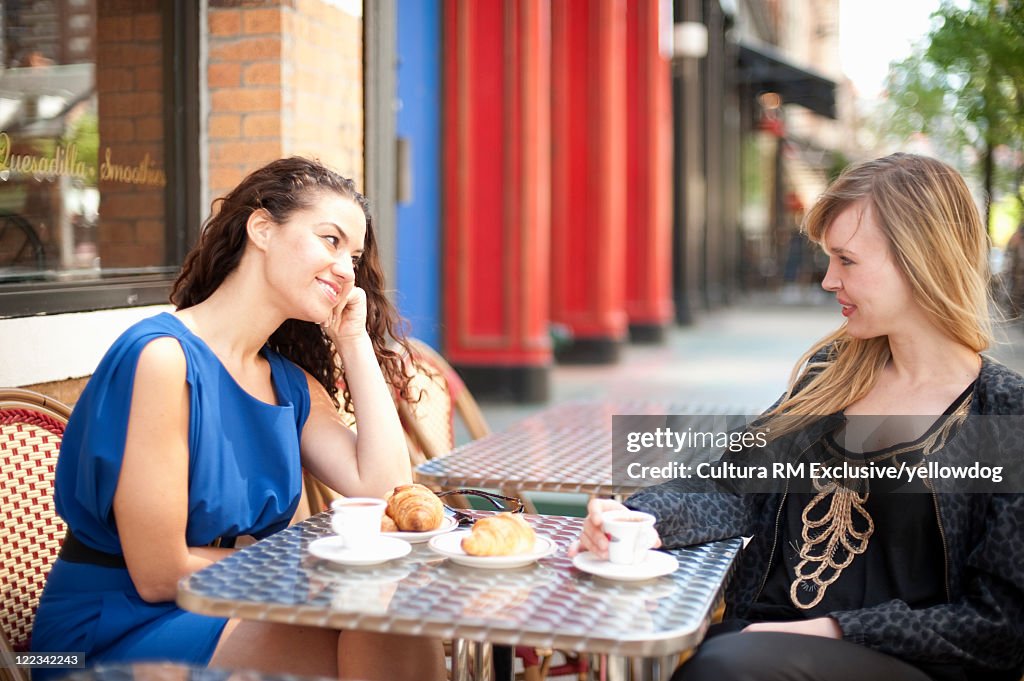 Women having coffee at sidewalk cafe