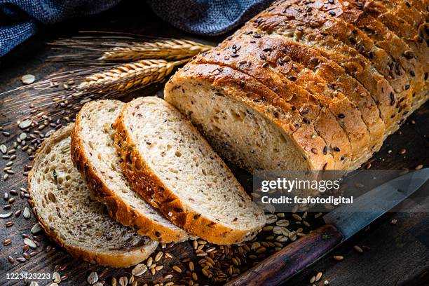 wholegrain and seeds sliced bread - carcaça imagens e fotografias de stock