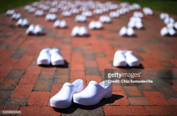The National Nurses United set out 88 empty pairs of shoes representing nurses that they say have died from COVID-19 while demonstrating in Lafayette...