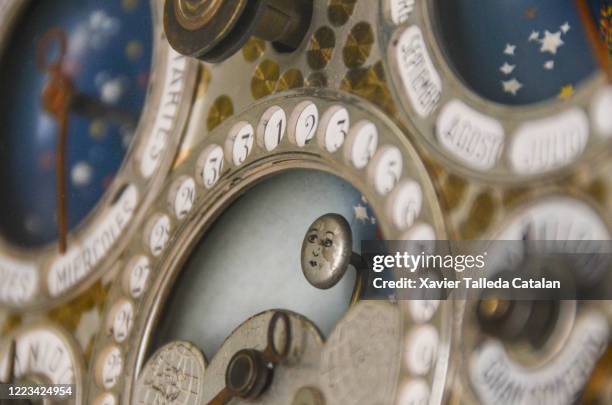 calendars of an old wall clock - lunar calendar stock pictures, royalty-free photos & images