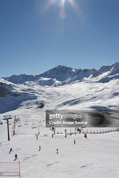 skiers at val d'isere resort, france - val d'isere stock pictures, royalty-free photos & images