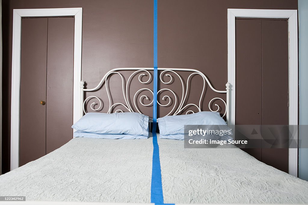 Double bed separated by blue line