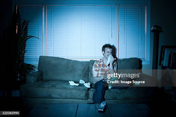 young man watching tv, crying - crying stock pictures, royalty-free photos & images