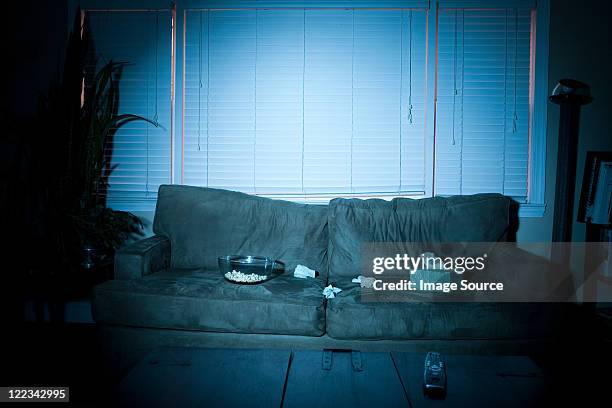 empty sofa with box of tissues and popcorn - living room dark stock pictures, royalty-free photos & images