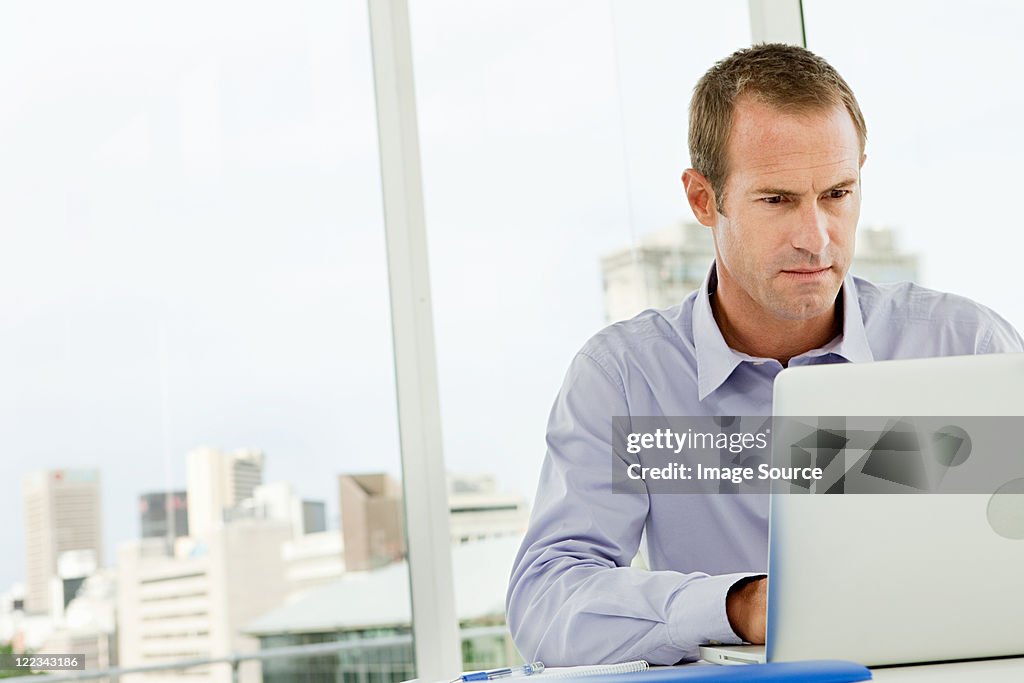 Businessman using laptop in office