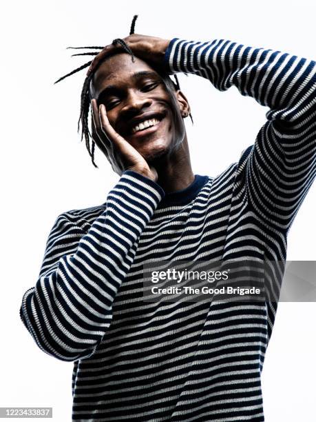 smiling man wearing striped shirt on white background - hand on hip bildbanksfoton och bilder