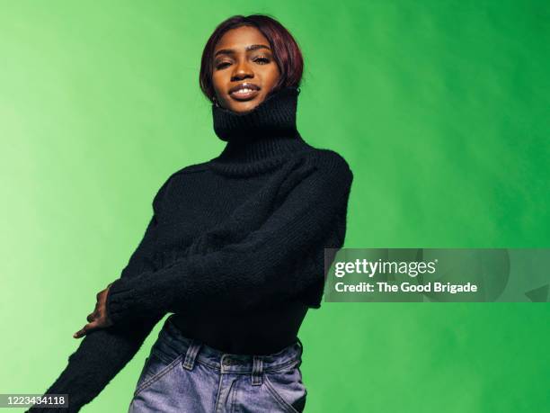 portrait of young woman smiling in studio - turtleneck stock pictures, royalty-free photos & images