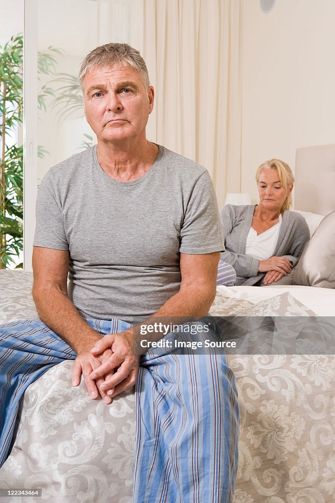 Worried couple in bedroom