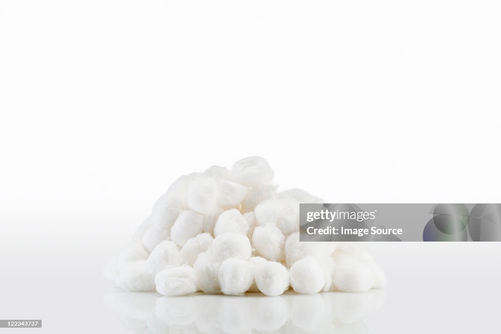 Closeup Of A Pile Of Cotton Balls Of Different Colors Stock Photo