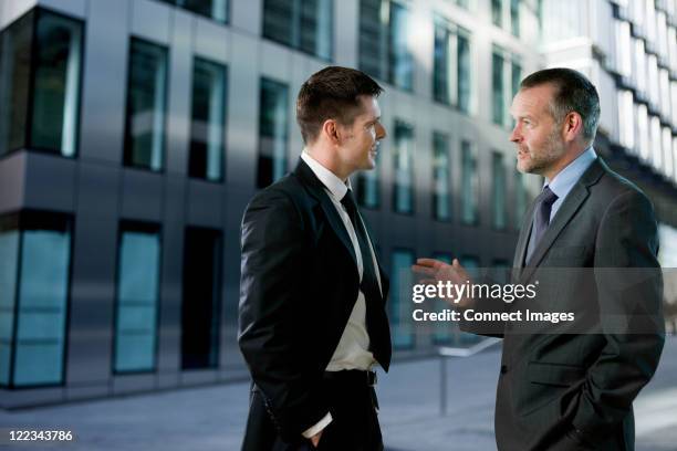 businessmen having conversation - suit jacket stock pictures, royalty-free photos & images