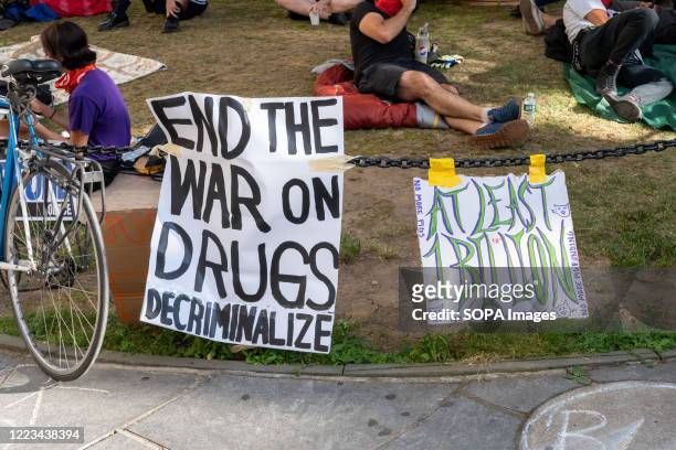 Placards calling for decriminalization of drugs are being displayed at the camp site during the demonstration. Similar to the Occupy Wall Street...
