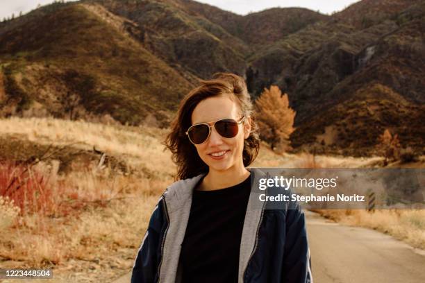 portrait of woman smiling at camera with mountain landscape behind her - ojai california foto e immagini stock