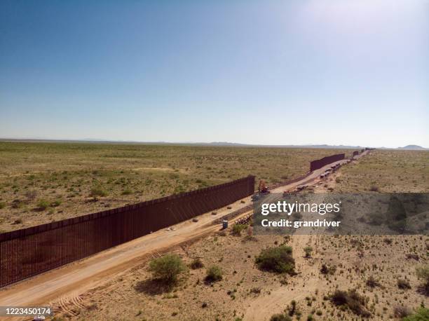 eine luftaufnahme der internationalen grenzmauer mit teilen, die sich noch im bau befinden - chihuahua desert stock-fotos und bilder