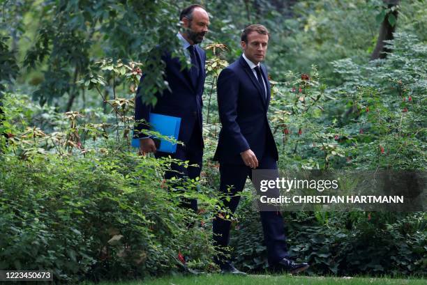 French President Emmanuel Macron and French Prime Minister Edouard Philippe arrive for a meeting with members of the Citizens' Convention on Climate...