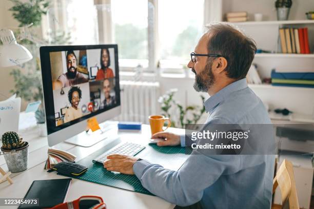 video call with team members - working from home stock pictures, royalty-free photos & images