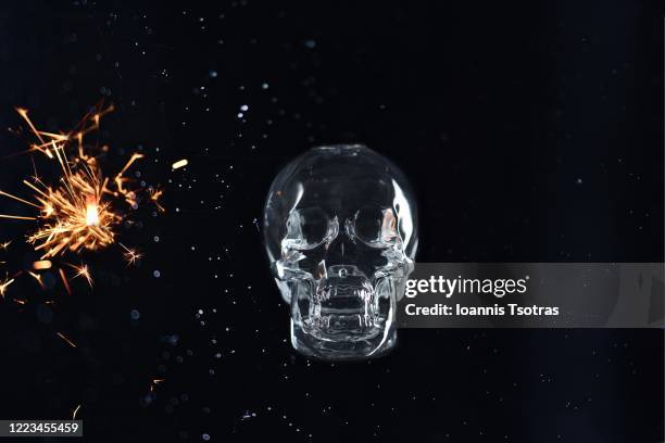 human skull with sparks over black background - hirnverbrannt stock-fotos und bilder