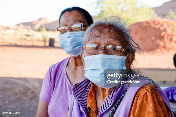 dos mujeres navajo de edad avanzada que usan máscaras faciales para protegerlas de la obtención del coronavirus - sistema inmunocomprometido fotografías e imágenes de stock