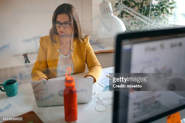 woman working at office - screen partition stock pictures, royalty-free photos & images