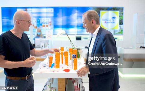 In this photo illustration a pharmacist advises a customer on June 12, 2020 in Bonn, Germany.