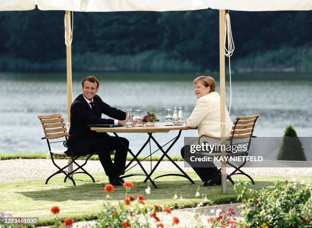 German Chancellor Angela Merkel meets with French President Emmanuel Macron before Germany takes over European Union's presidency on June 29, 2020 at...