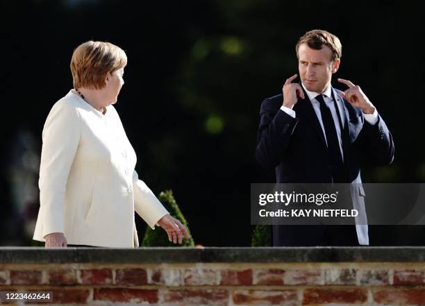 German Chancellor Angela Merkel and French President Emmanuel Macron arrive to give a press conference following a meeting on June 29, 2020 at the...