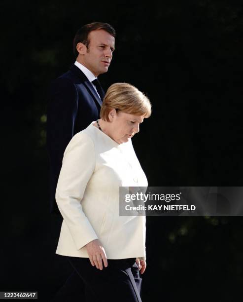 German Chancellor Angela Merkel and French President Emmanuel Macron arrive to give a press conference following a meeting on June 29, 2020 at the...
