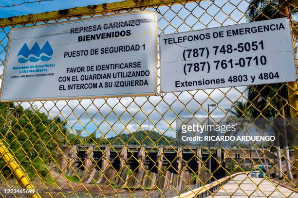The main entrance to the gates of the unusually low drought affected Carraizo dam is seen closed in Trujillo Alto, Puerto Rico on June 29, 2020. -...