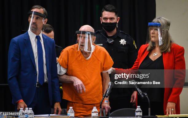 Joseph James DeAngelo, center, and his public defenders Joseph Cress, left, and Diane Howard, right, wear face shields as they stand as Sacramento...